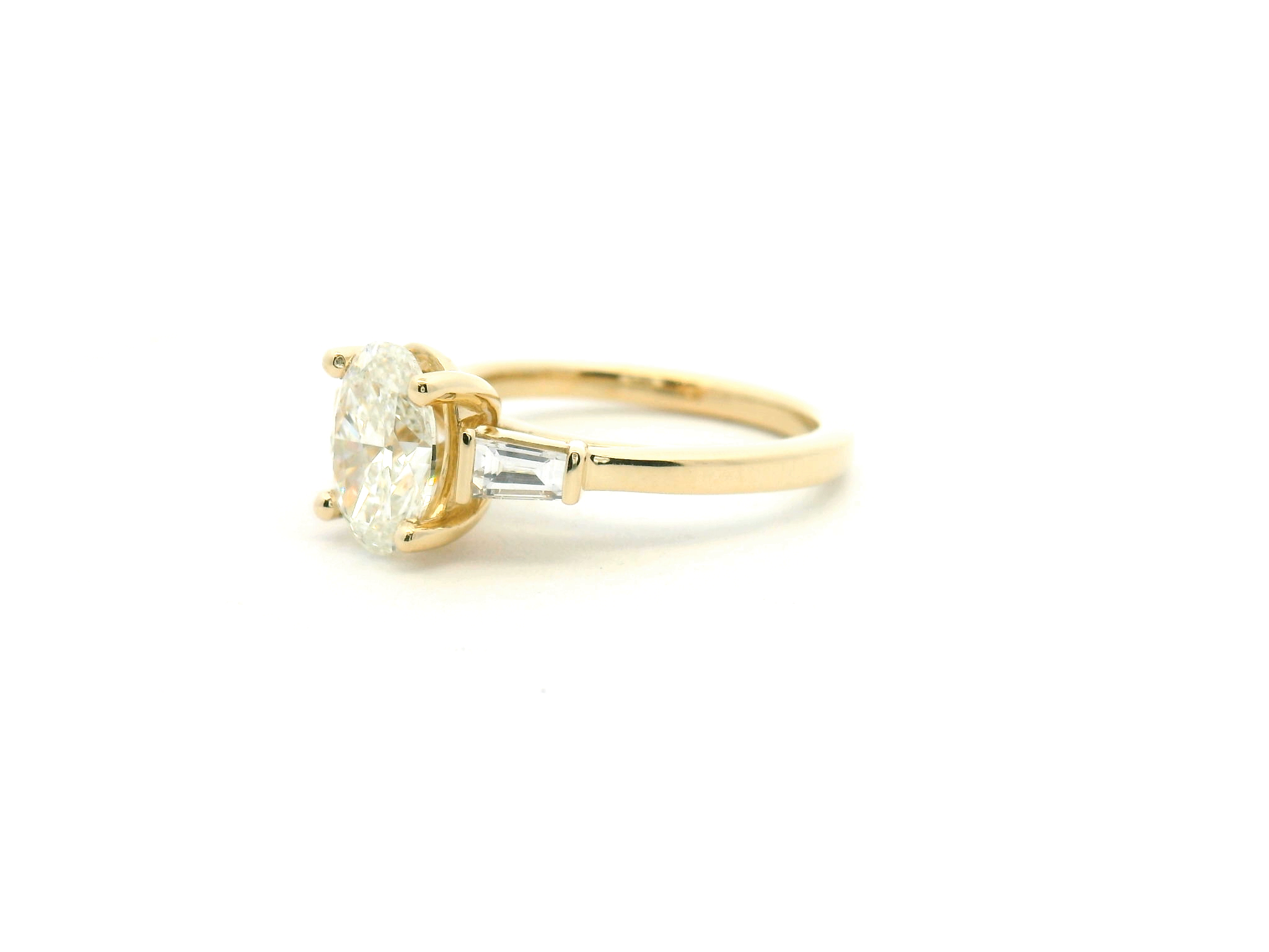 Oval Diamond Three-Stone Engagement Ring with Tapered Baguettes