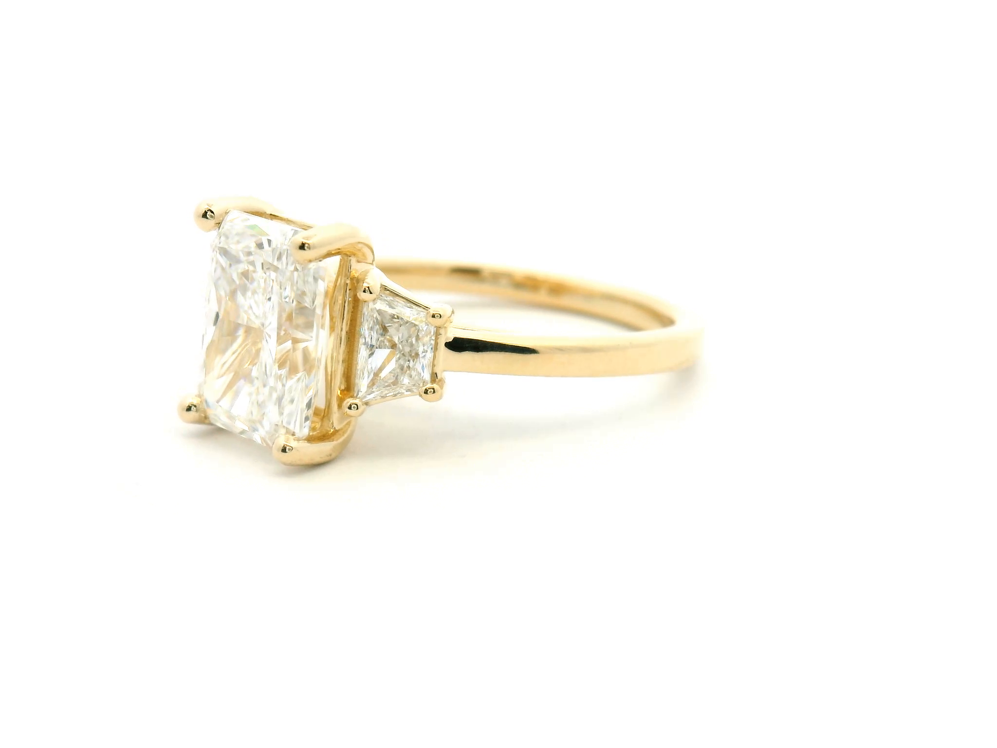 Radiant Cut Three-Stone Diamond Engagement Ring with Trapezoid Side Stones