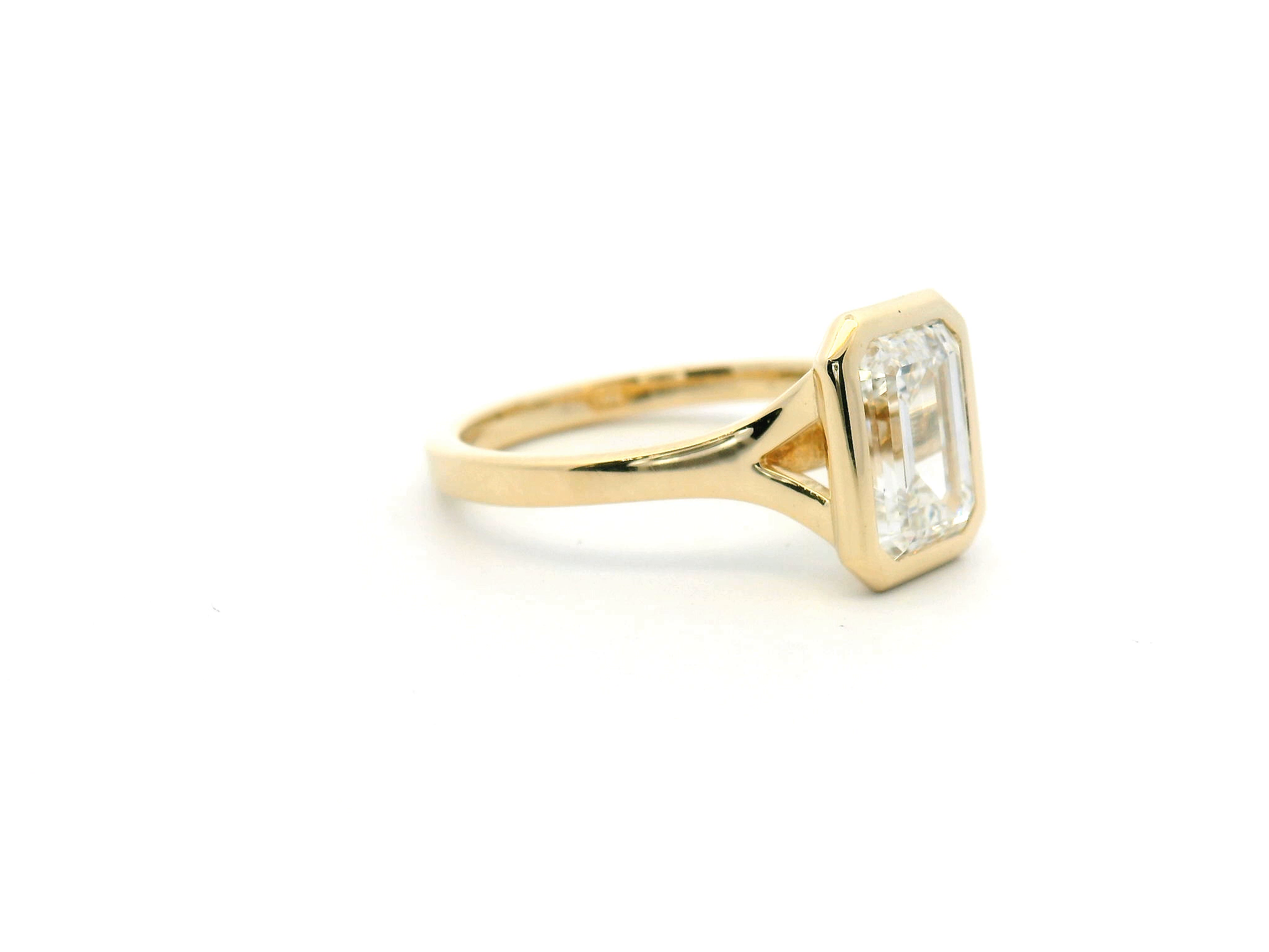 Emerald Cut Diamond Split Shank Bezel Engagement Ring