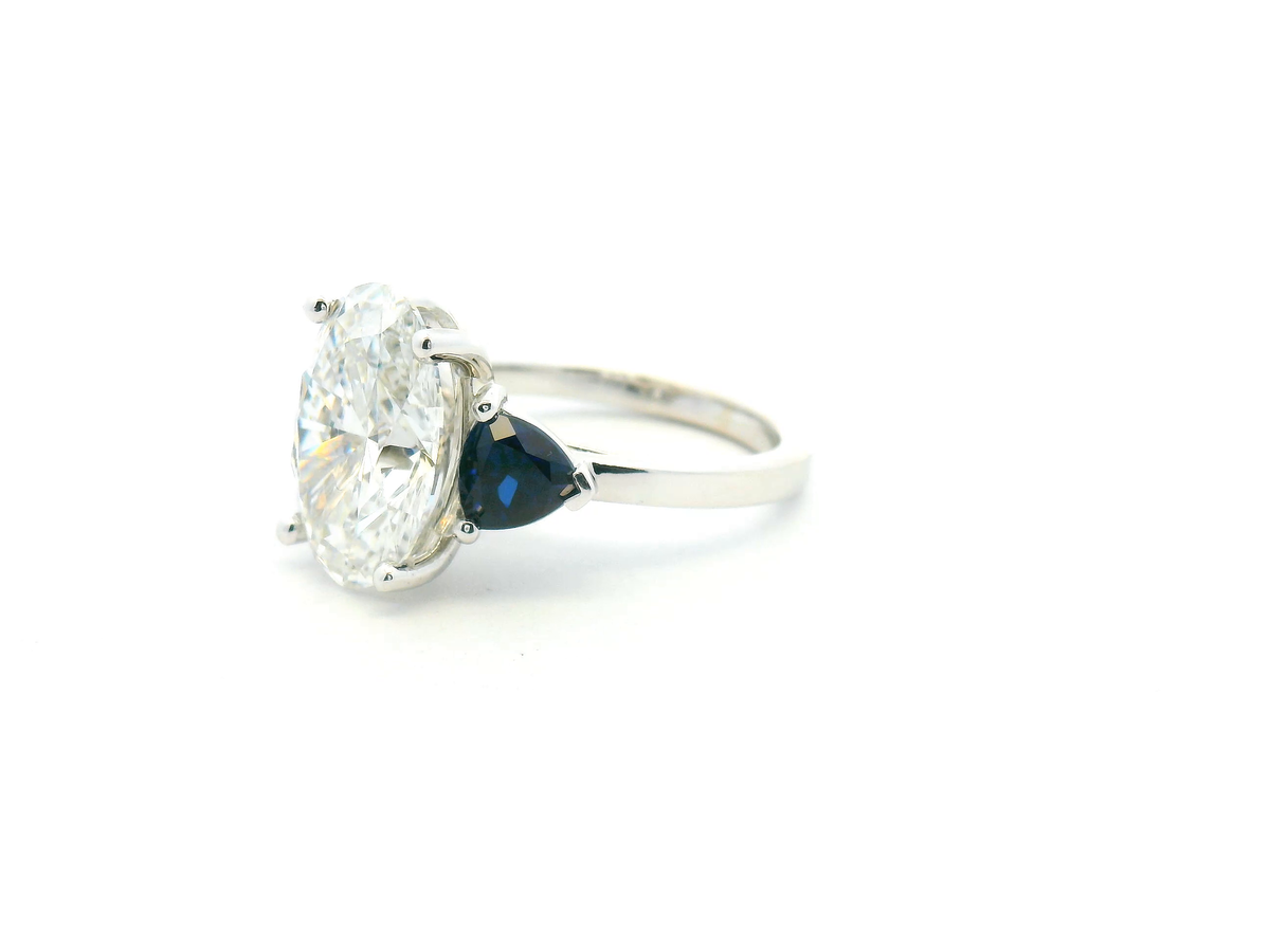 Oval Diamond & Trillion Sapphire Three-Stone Engagement Ring