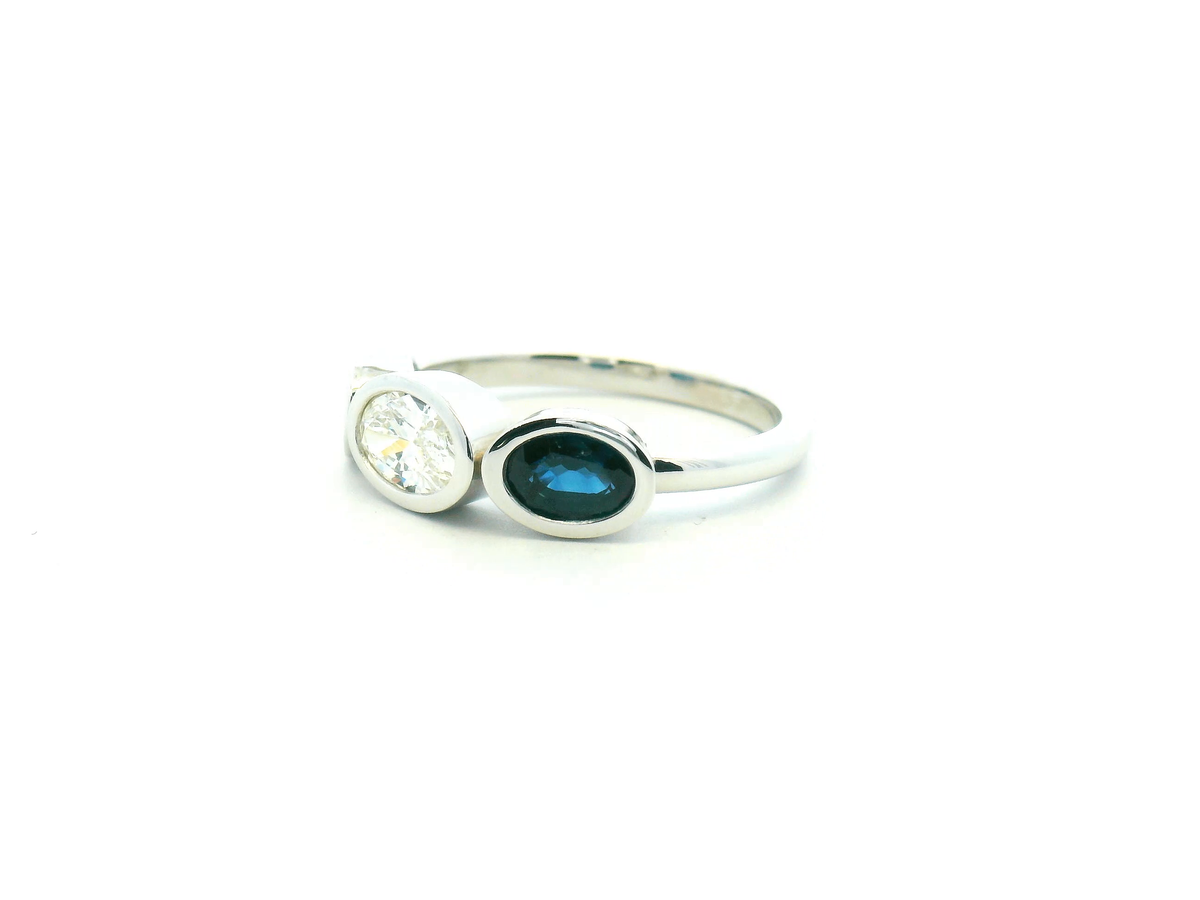 Oval Diamond and Blue Sapphire Three Stone Bezel Set Ring
