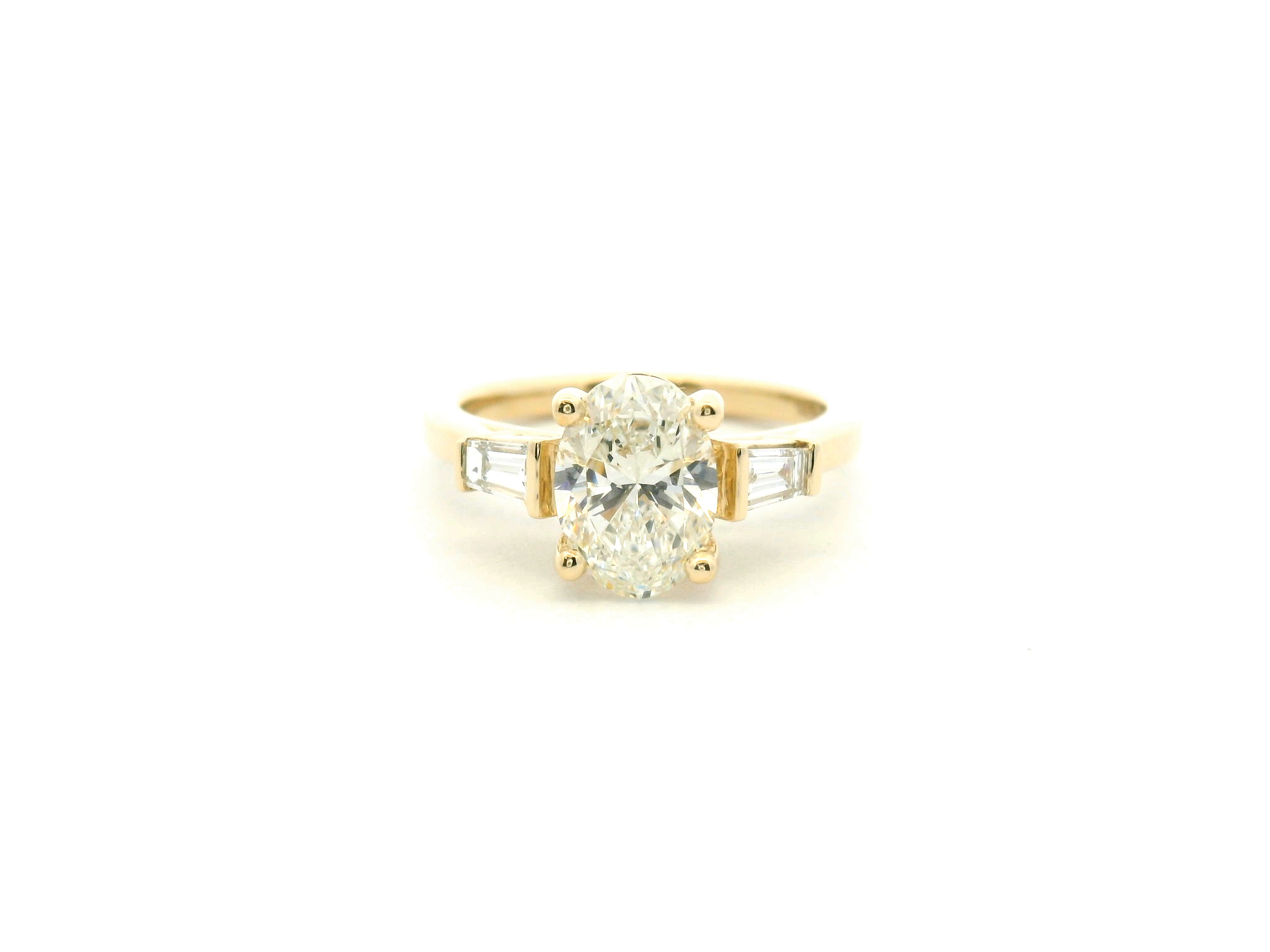 Oval Diamond Three-Stone Engagement Ring with Tapered Baguettes