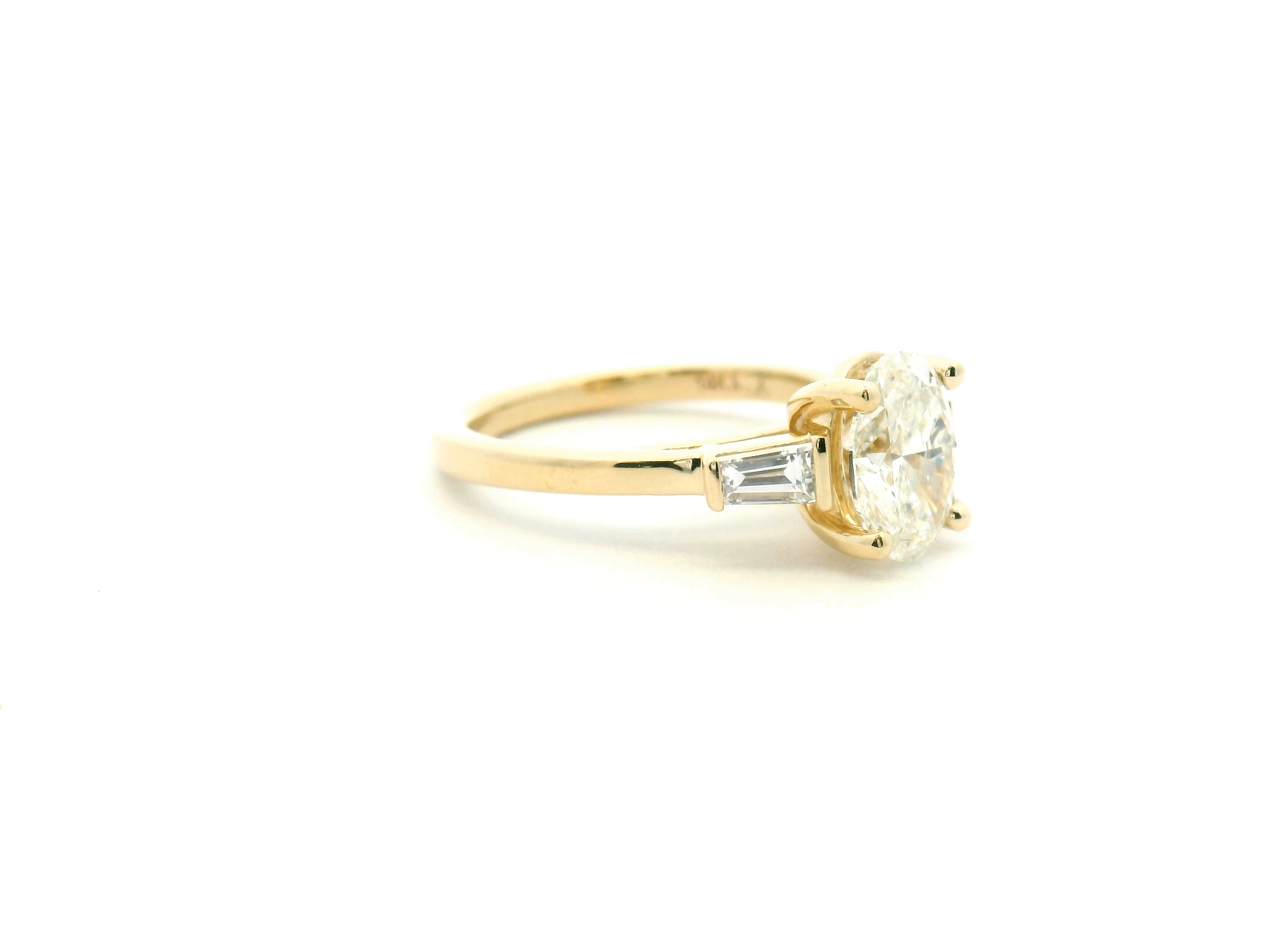 Oval Diamond Three-Stone Engagement Ring with Tapered Baguettes