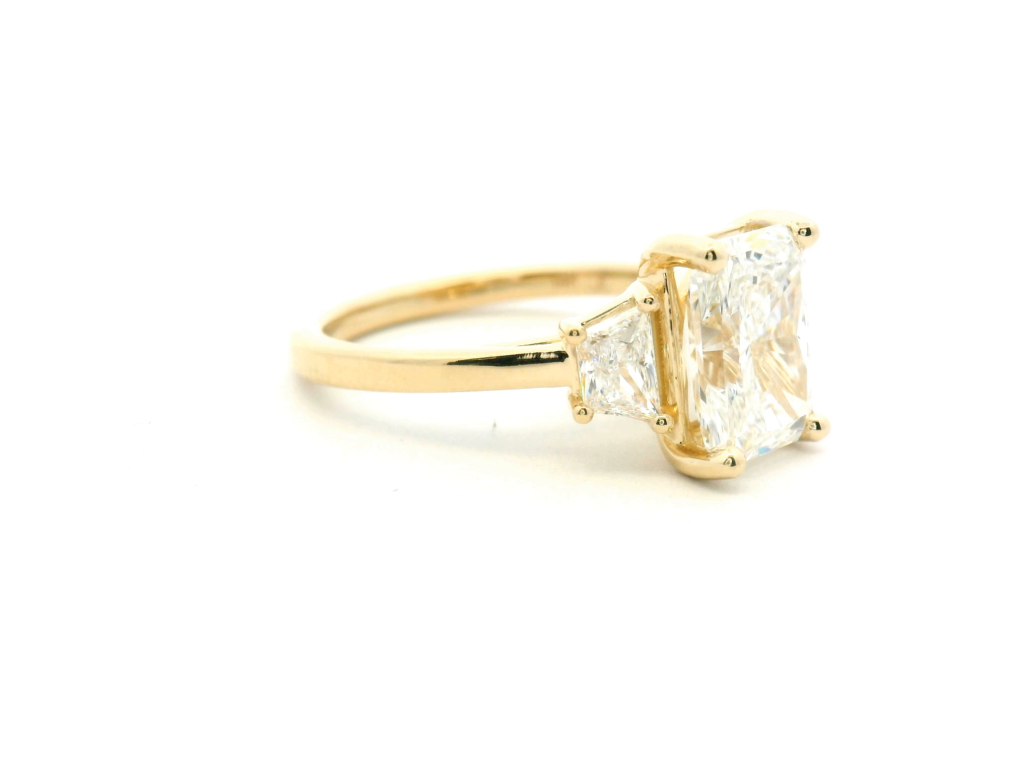Radiant Cut Three-Stone Diamond Engagement Ring with Trapezoid Side Stones