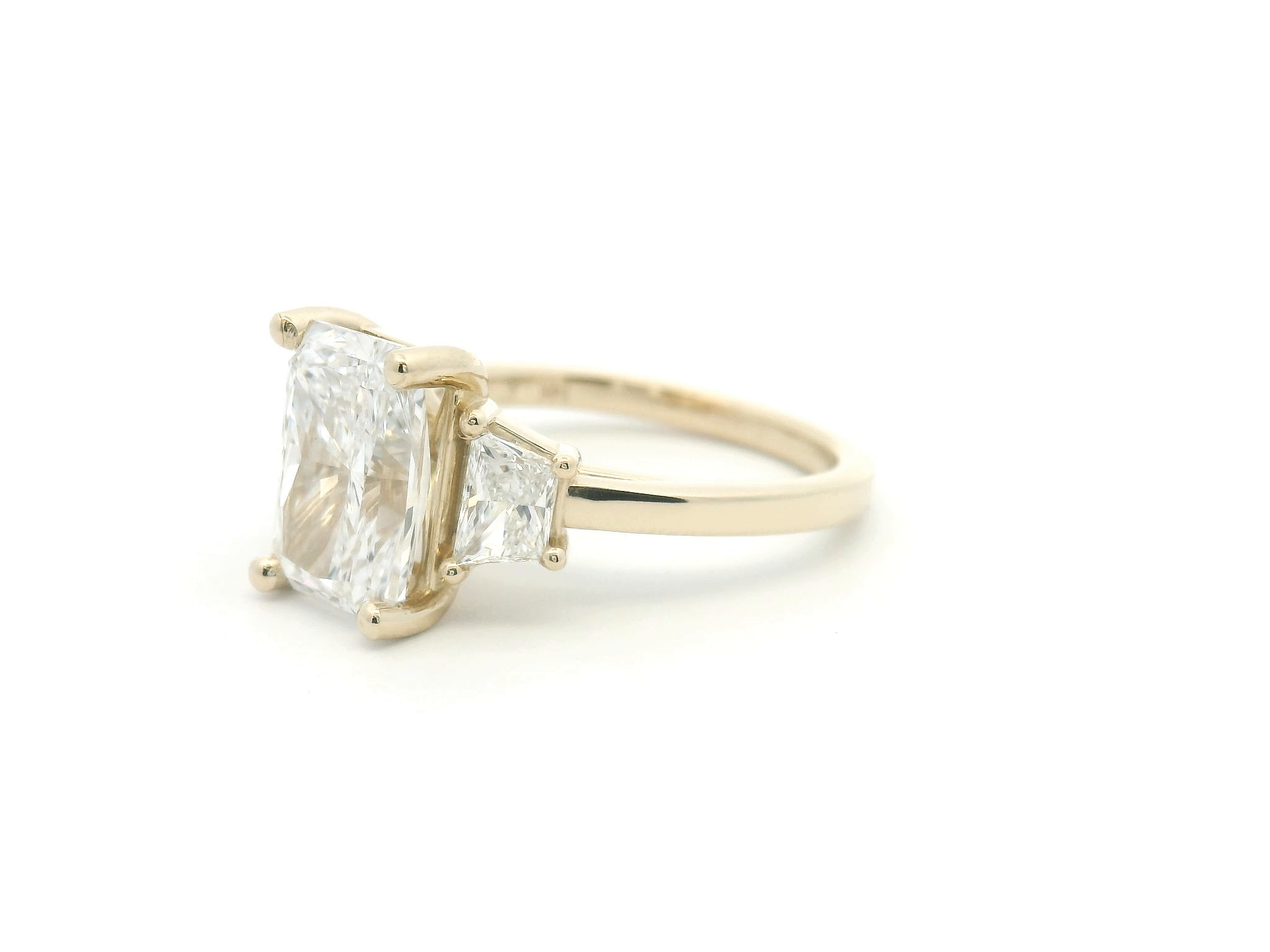 Radiant Cut Diamond Three Stone Ring with Trapezoid Side Stones