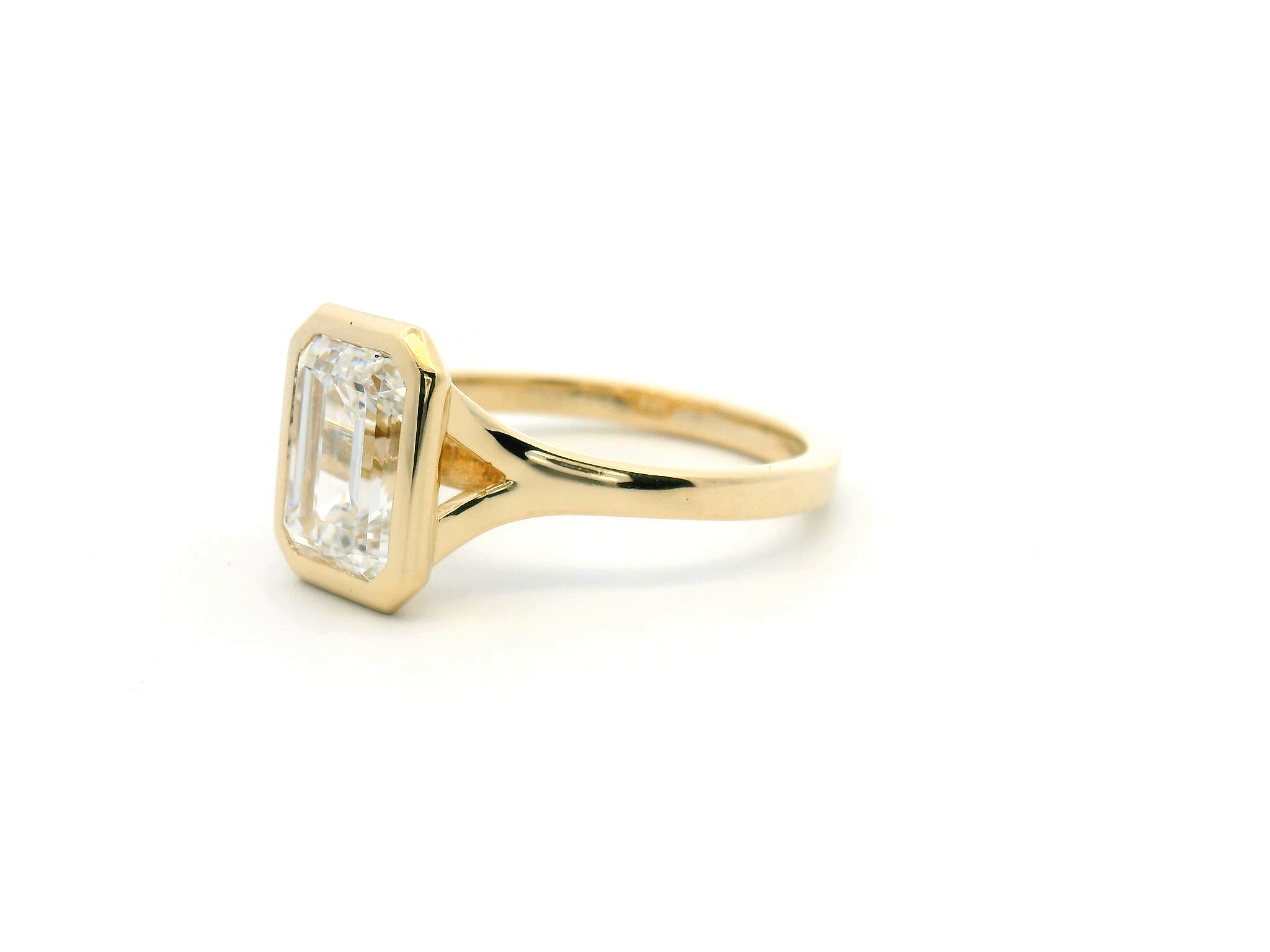 Emerald Cut Diamond Split Shank Bezel Engagement Ring
