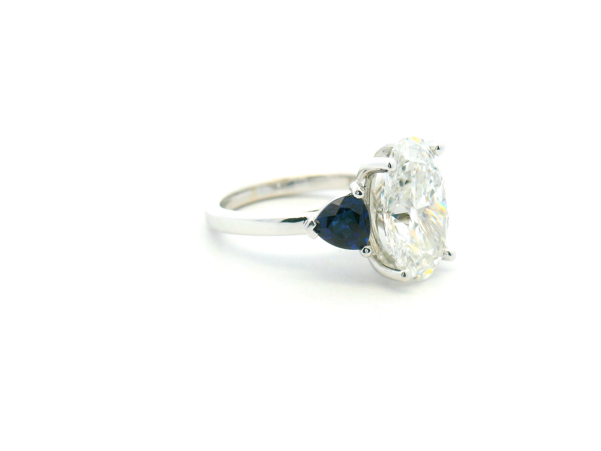 Oval Diamond & Trillion Sapphire Three-Stone Engagement Ring