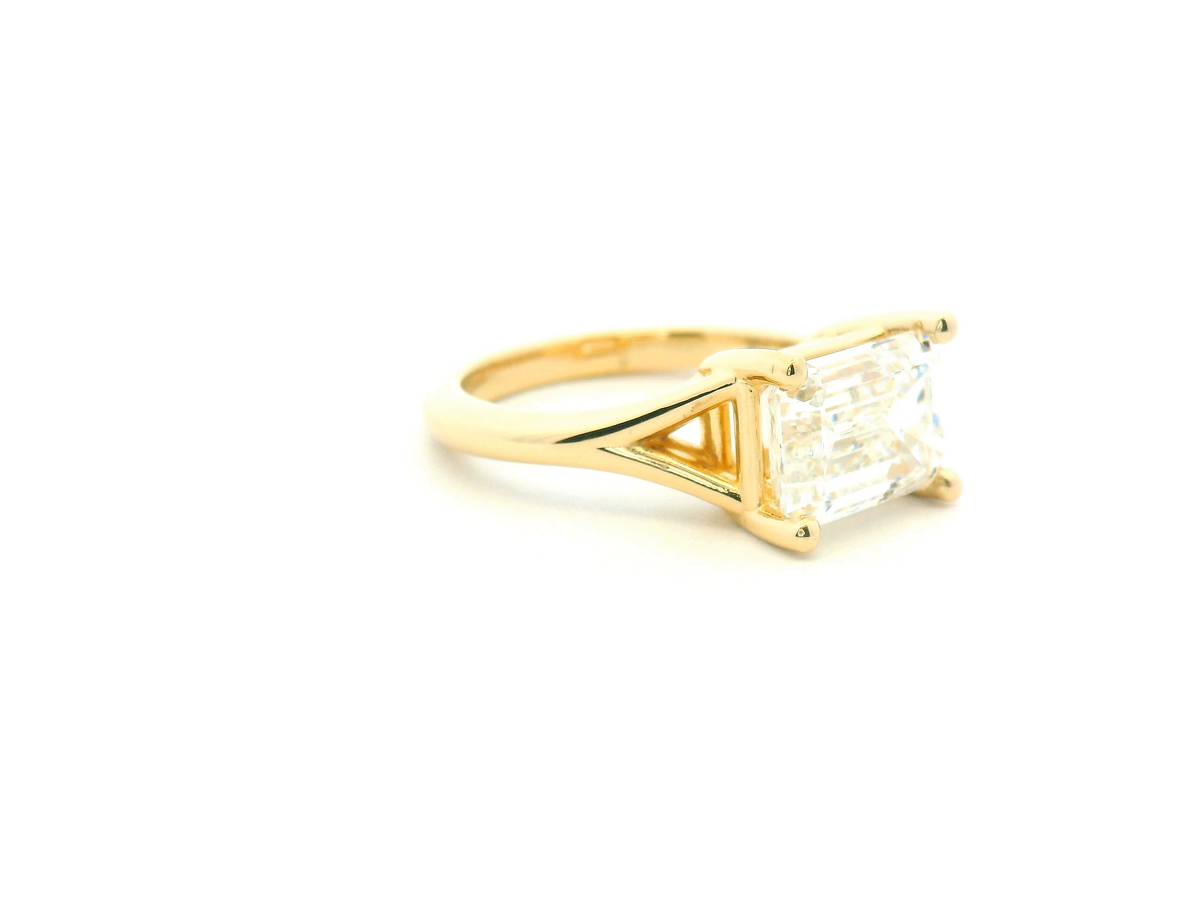 East-West Emerald Cut Split Shank Solitaire Engagement Ring