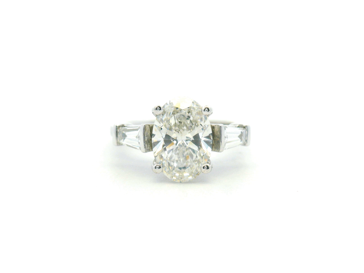 Oval Three Stone Engagement Ring with Tapered Baguette Side Stone