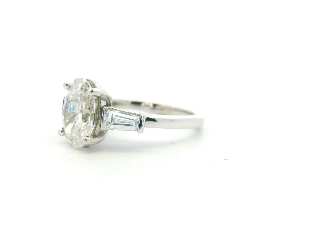 Oval Three Stone Engagement Ring with Tapered Baguette Side Stone