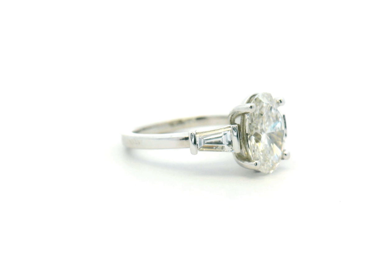 Oval Three Stone Engagement Ring with Tapered Baguette Side Stone
