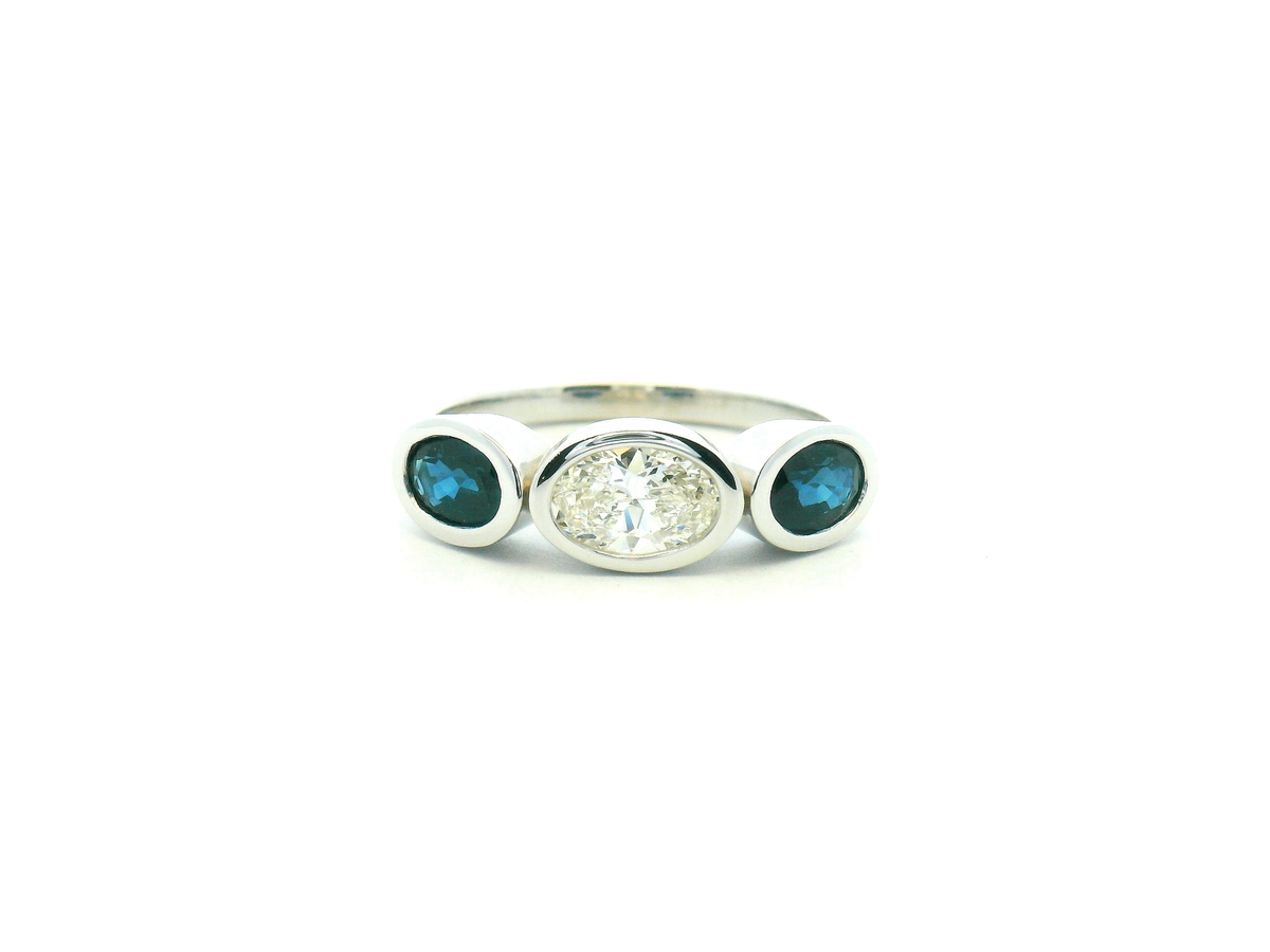 Oval Diamond and Blue Sapphire Three Stone Bezel Set Ring