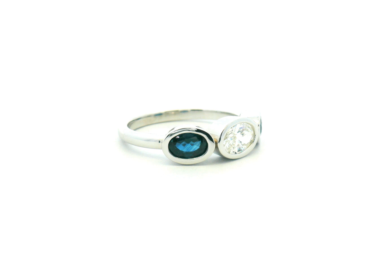 Oval Diamond and Blue Sapphire Three Stone Bezel Set Ring